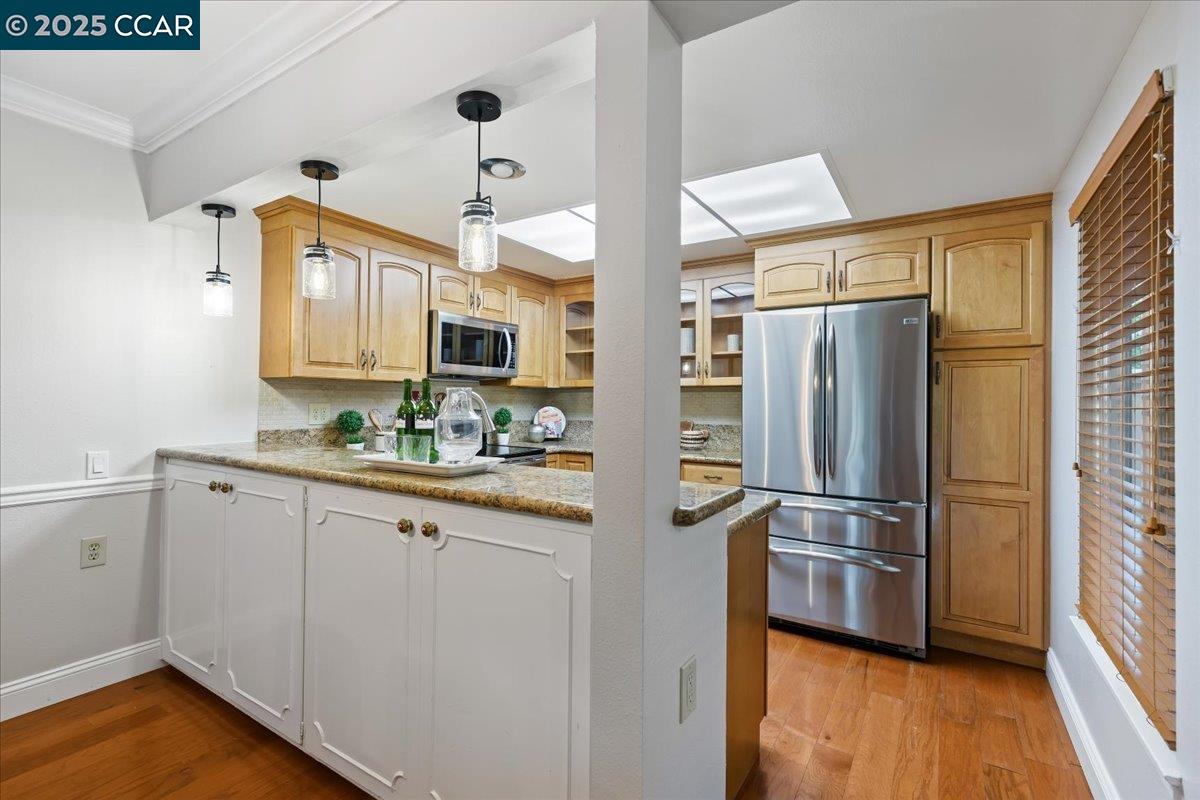 1857 Golden Rain Road, Unit 2 Walnut Creek, CA 94595 - Photo 19 of 39 a kitchen with granite countertop a refrigerator and a sink