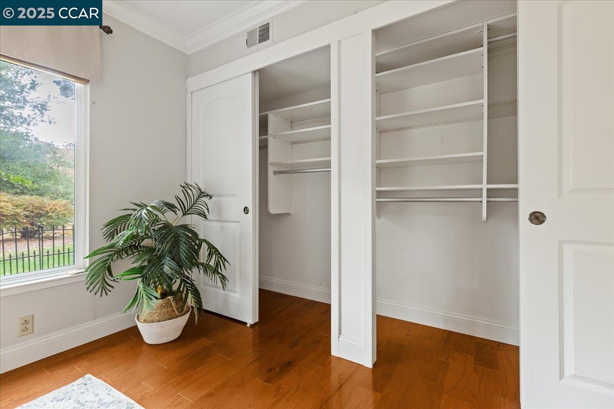 1857 Golden Rain Road, Unit 2 Walnut Creek, CA 94595 - Photo 24 of 39 a room with wooden floor and a potted plant