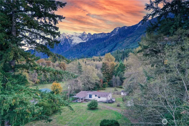 a view of a wooden house with a yard