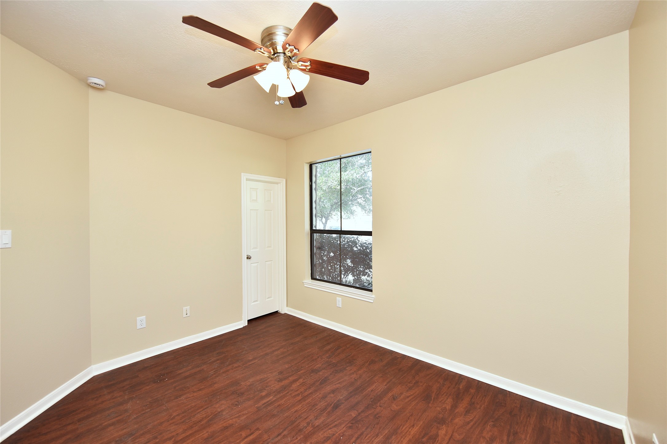 29703 Meridian Hill Drive Spring, TX 77386 - Photo 23 of 43 an empty room with wooden floor chandelier fan and windows