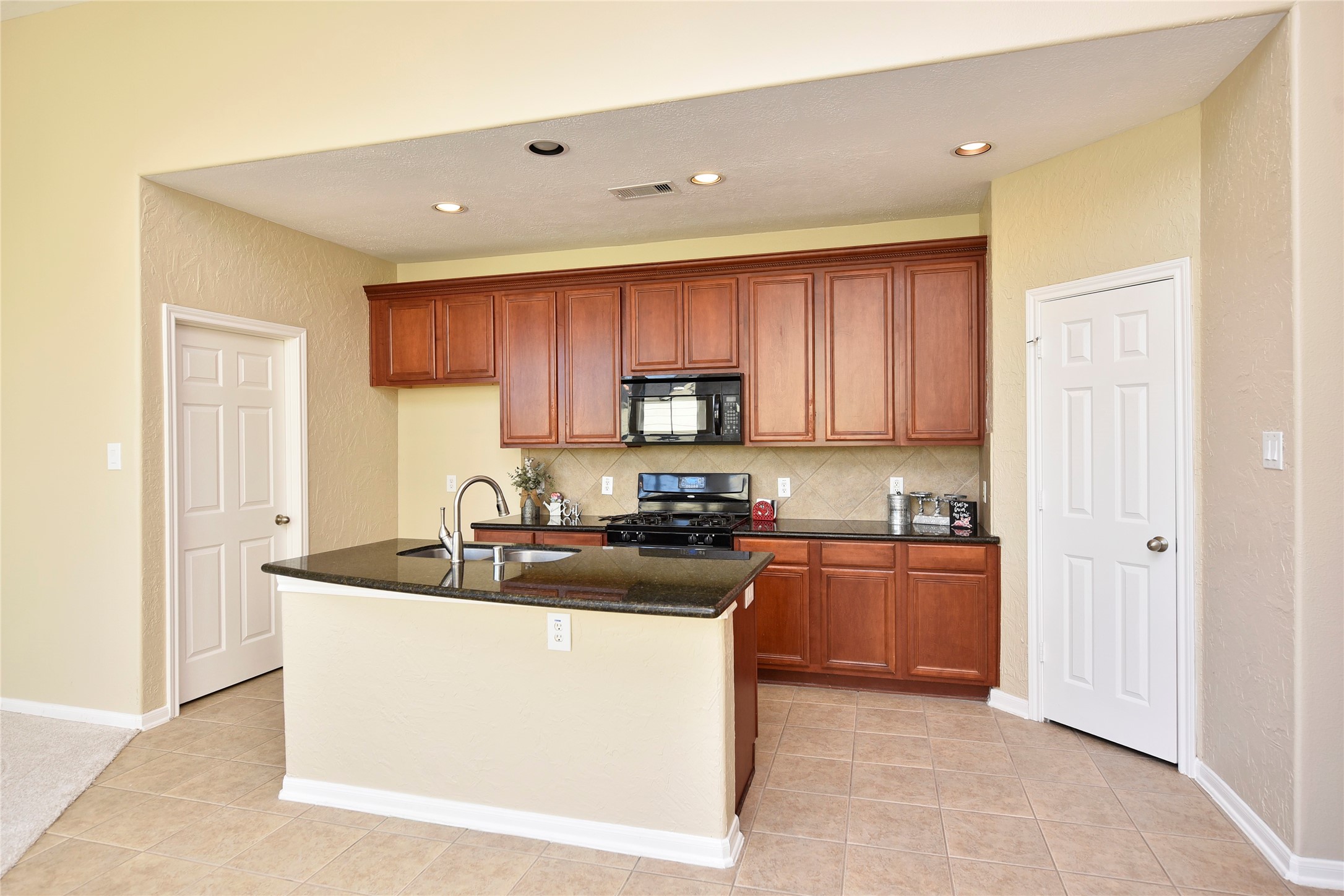 29703 Meridian Hill Drive Spring, TX 77386 - Photo 4 of 43 a kitchen with stainless steel appliances granite countertop a sink stove and refrigerator