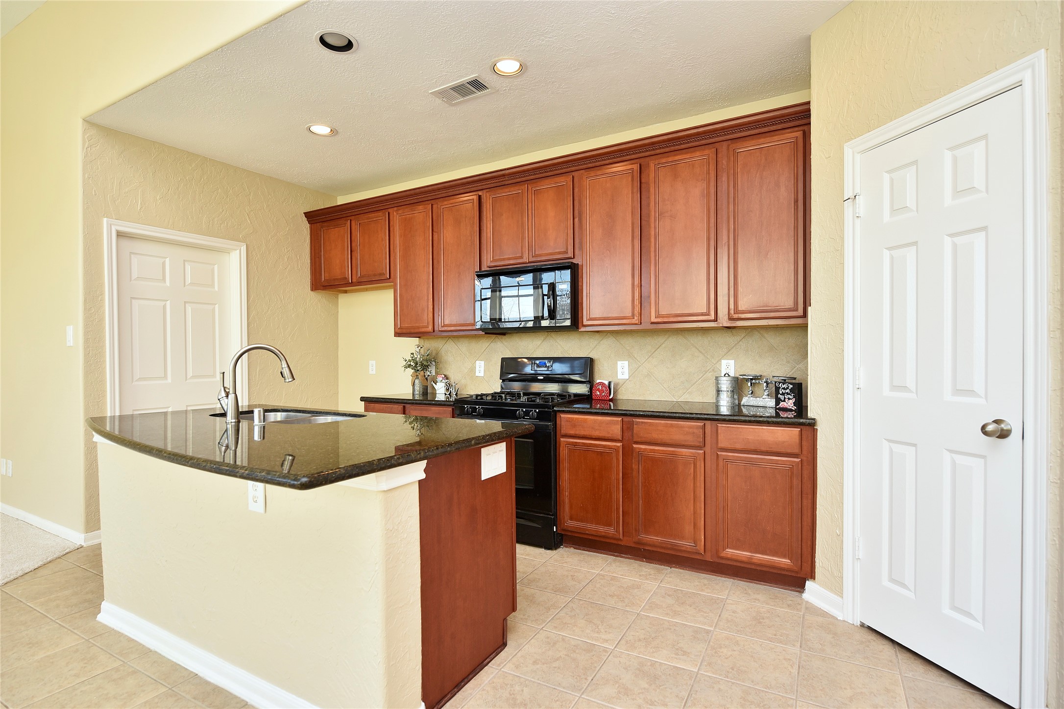 29703 Meridian Hill Drive Spring, TX 77386 - Photo 5 of 43 a kitchen with stainless steel appliances granite countertop a sink stove and cabinets