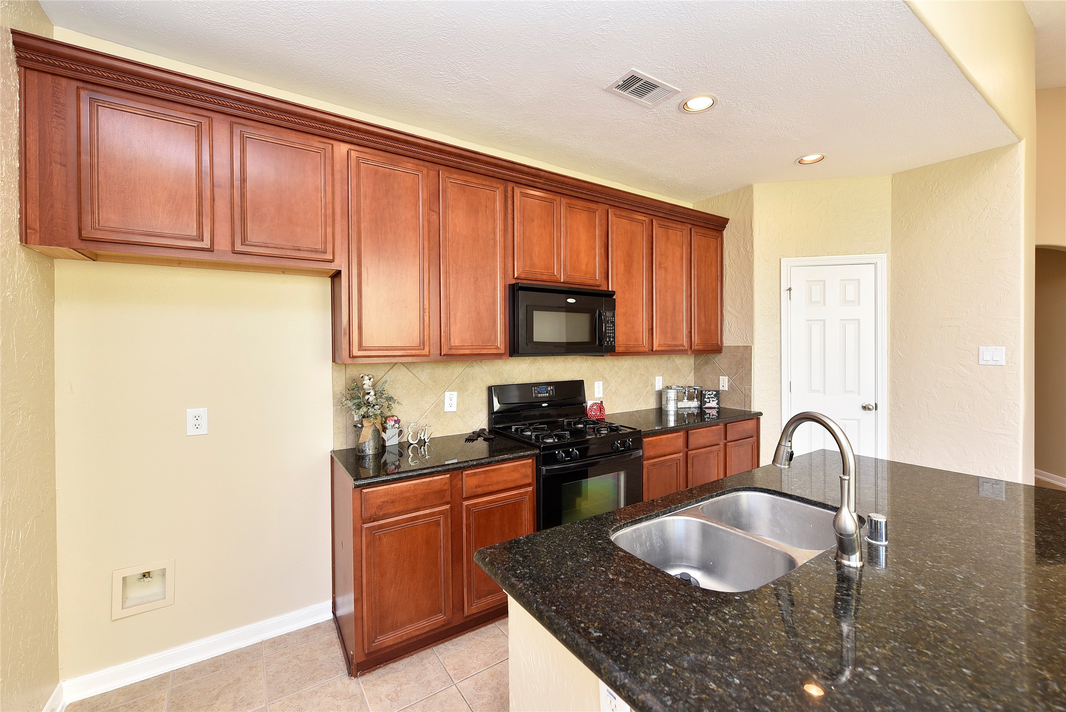 29703 Meridian Hill Drive Spring, TX 77386 - Photo 8 of 43 a kitchen with granite countertop stainless steel appliances a sink a stove and a refrigerator