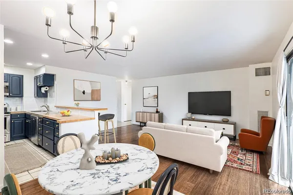 a living room with furniture a dining table and a fireplace