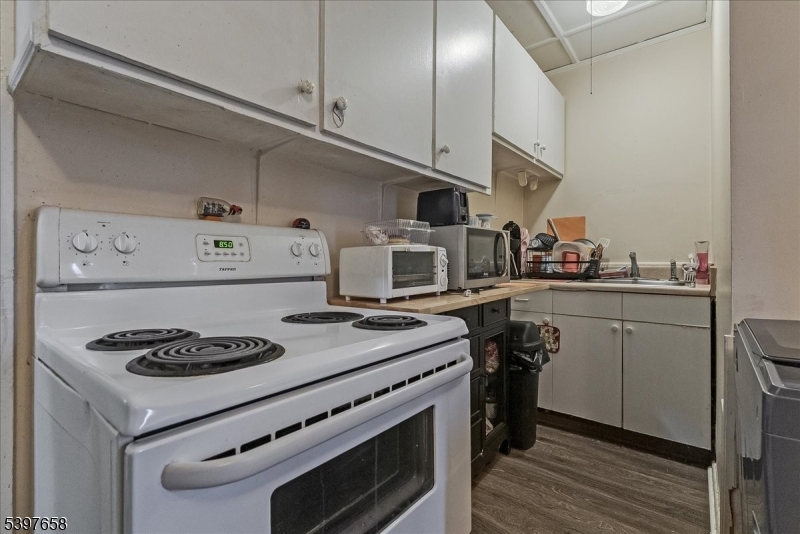 104 Ridgedale Avenue Cedar Knolls, NJ 07927 - Photo 15 of 47 a kitchen with a stove and white cabinets