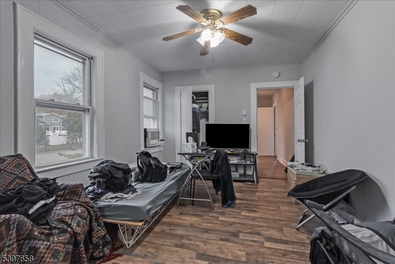 104 Ridgedale Avenue Cedar Knolls, NJ 07927 - Photo 40 of 47 a living room with furniture and a flat screen tv with wooden floor