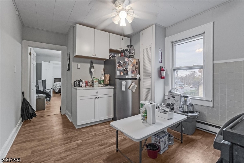 104 Ridgedale Avenue Cedar Knolls, NJ 07927 - Photo 42 of 47 a kitchen with a refrigerator a stove cabinets dining table and chairs