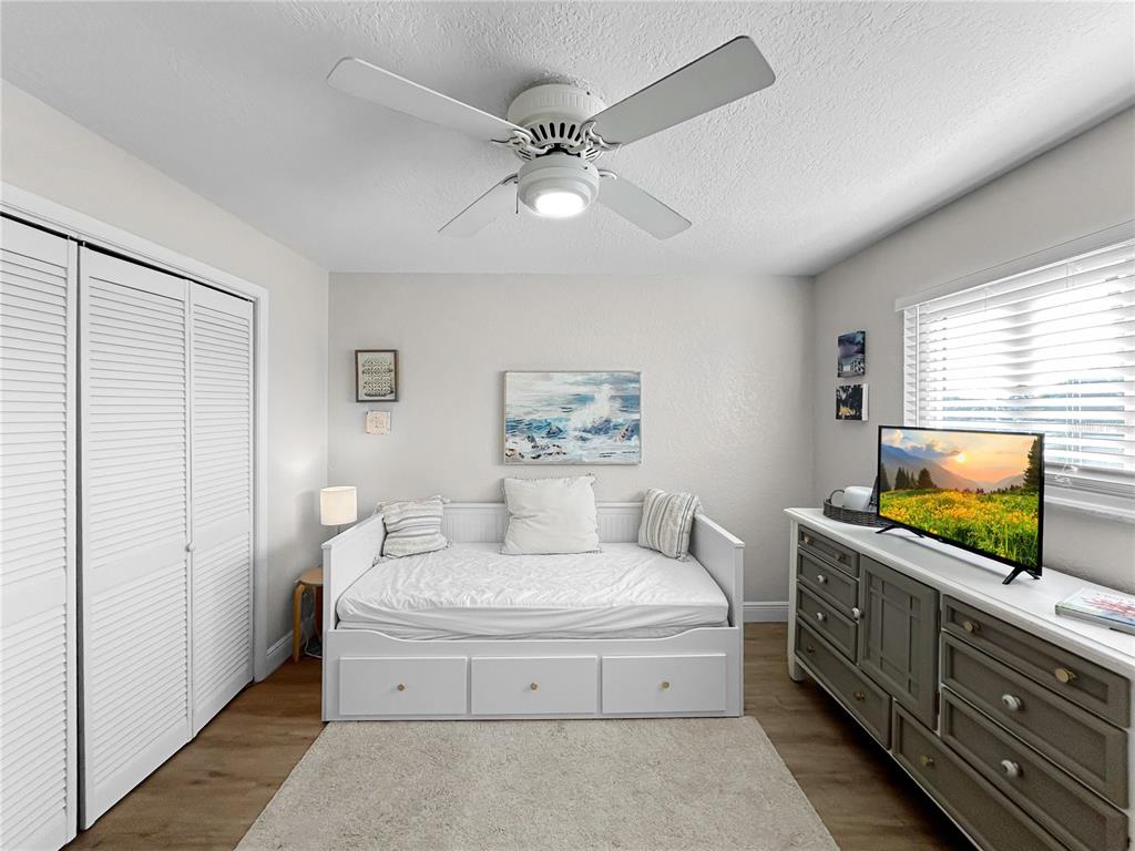 2505 Bay Boulevard, Unit 1 Indian Rocks Beach, FL 33785 - Photo 16 of 25 a spacious bedroom with a large bed and a flat screen tv