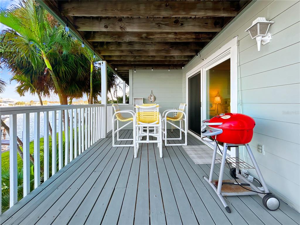 2505 Bay Boulevard, Unit 1 Indian Rocks Beach, FL 33785 - Photo 22 of 25 a view of a chairs and table on the wooden floor