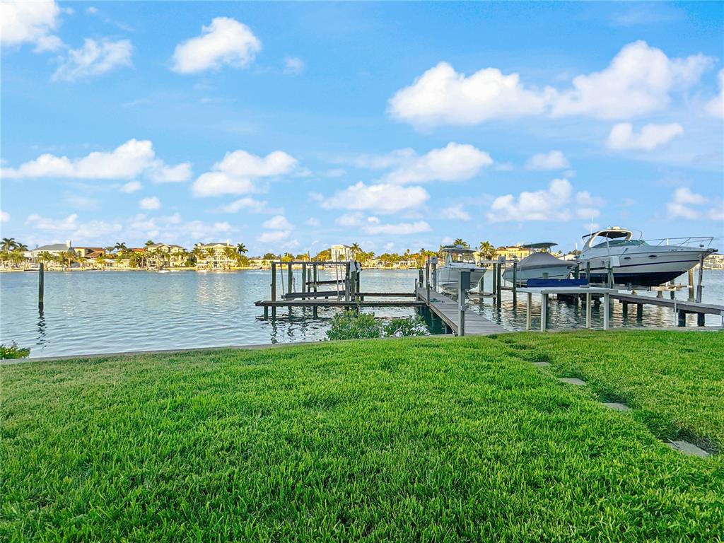 2505 Bay Boulevard, Unit 1 Indian Rocks Beach, FL 33785 - Photo 5 of 25 a view of a lake with a big yard and large trees