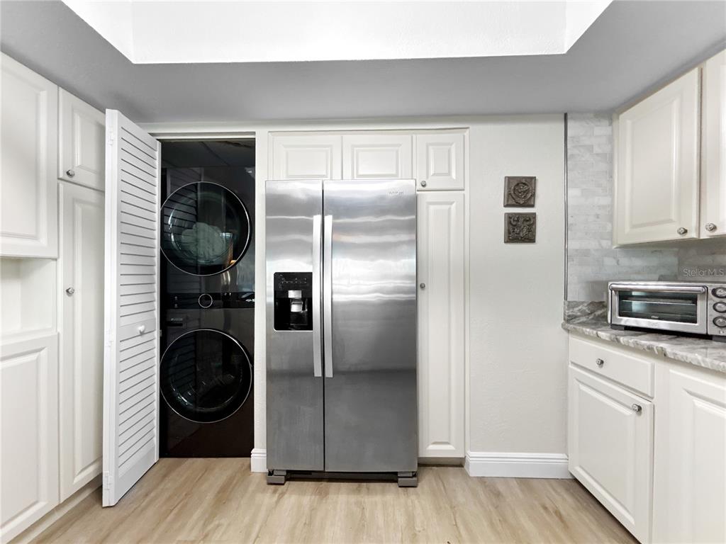 2505 Bay Boulevard, Unit 1 Indian Rocks Beach, FL 33785 - Photo 7 of 25 a kitchen with stainless steel appliances granite countertop a refrigerator and a stove top oven