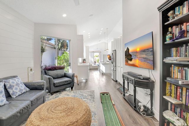 a living room with furniture and a book shelf