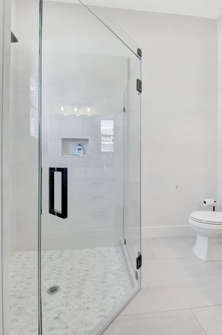 a bathroom with a toilet sink and shower