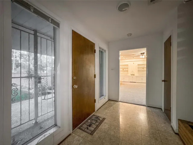 a view of livingroom with hallway and wooden floor