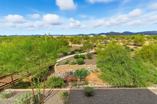 a view of a city with flower plants and wooden fence