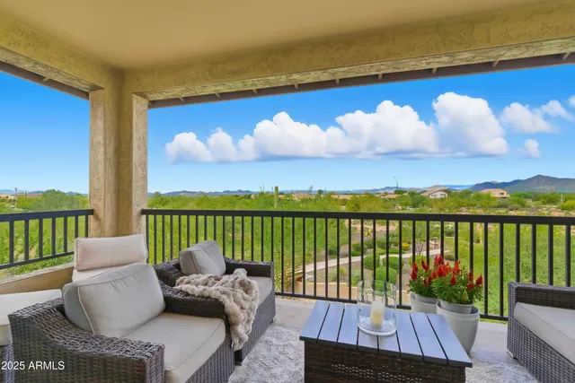 a view of balcony with couches and wooden floor