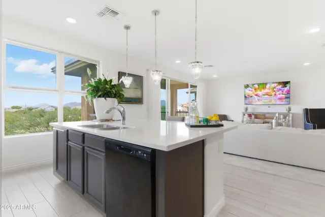 a kitchen with kitchen island a sink appliances and a counter top space