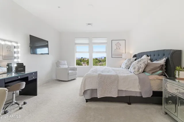 a bedroom with a bed and a flat screen tv