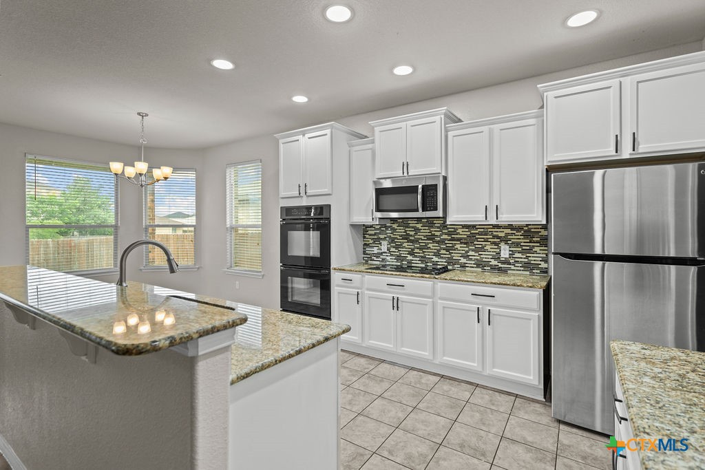 Undisclosed Address Temple, TX 76502 - Photo 11 of 36 a kitchen with stainless steel appliances granite countertop a sink refrigerator and cabinets