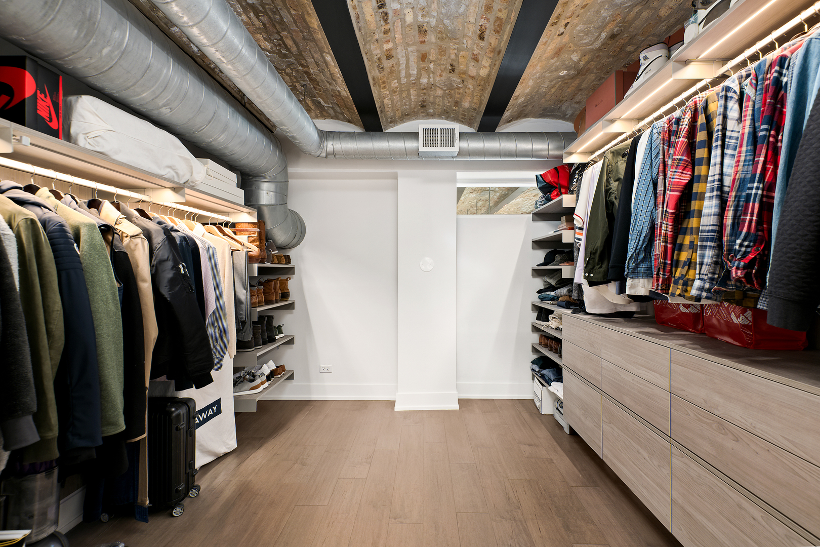 2101 West Rice Street, Unit 308 Chicago, IL 60622 - Photo 18 of 22 a view of walk in closet with clothes and shoes