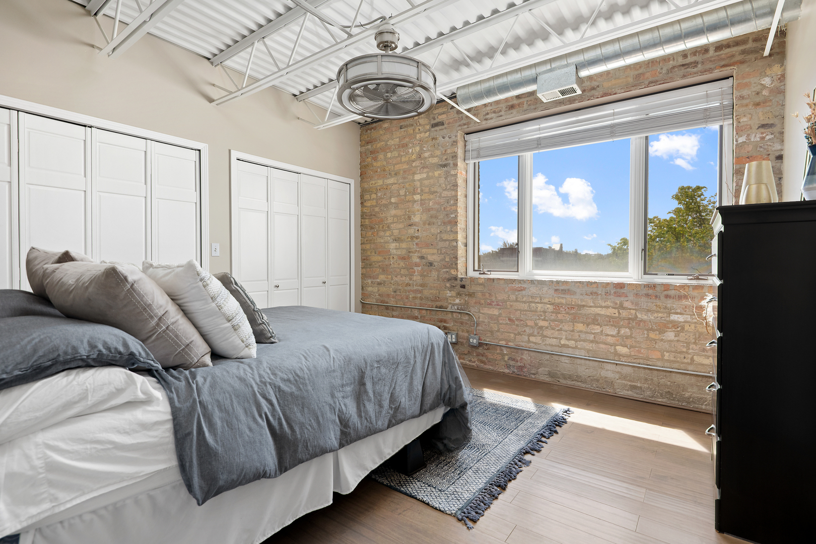 2101 West Rice Street, Unit 308 Chicago, IL 60622 - Photo 19 of 22 a bedroom with a bed and a flat screen tv