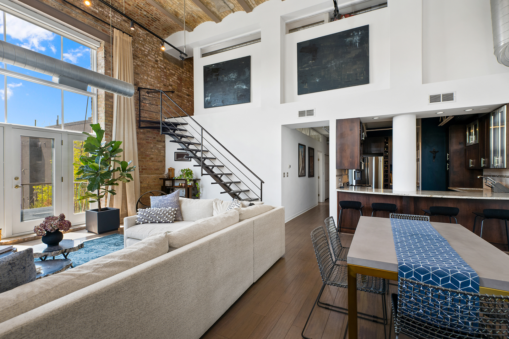 2101 West Rice Street, Unit 308 Chicago, IL 60622 - Photo 6 of 22 a view of a patio with couches table and chairs with wooden floor