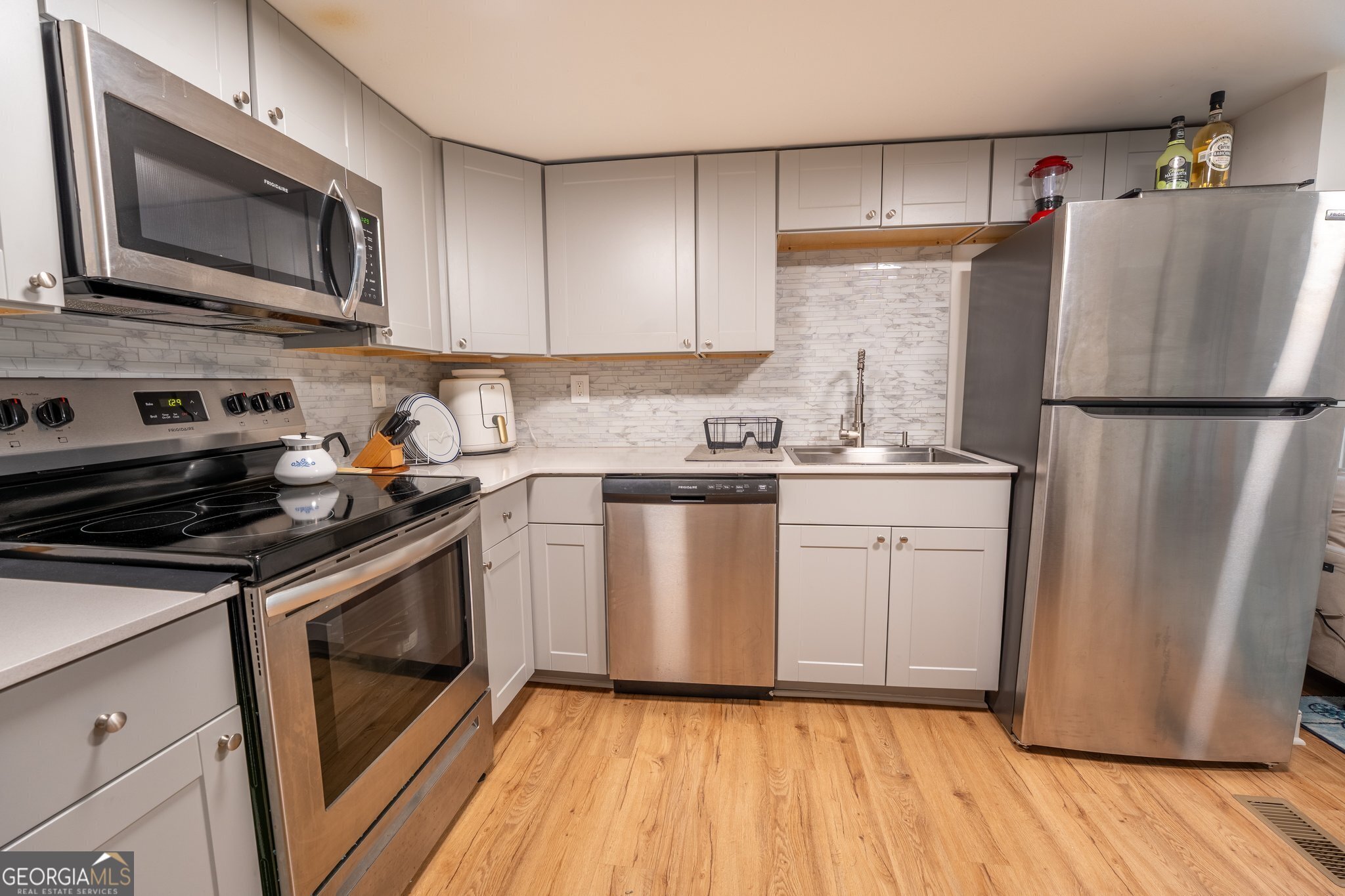 128 Branch Street Toccoa, GA 30577 - Photo 9 of 38 a kitchen with a refrigerator sink and microwave