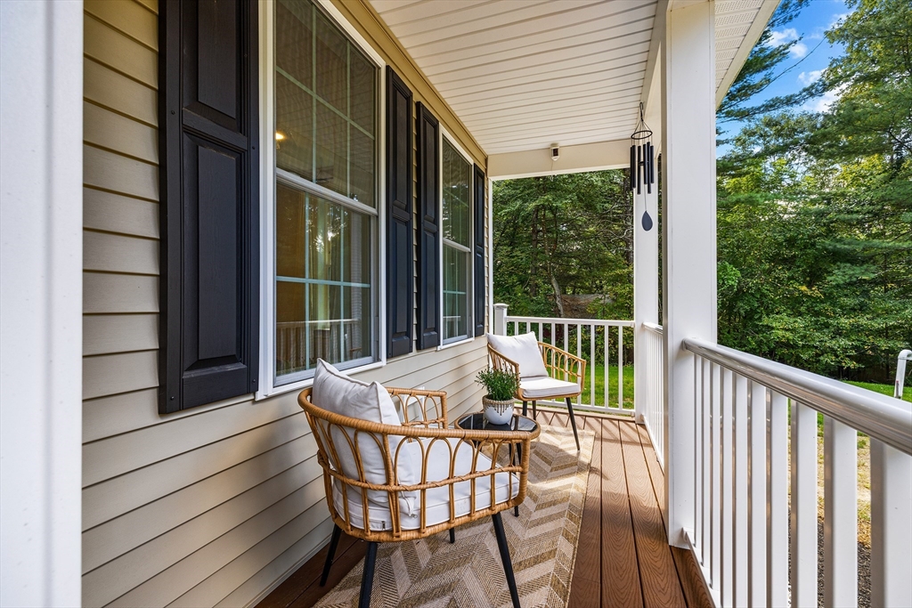 236 Pepperell Road Groton, MA 01450 - Photo 4 of 42 a view of a chair and table in the balcony