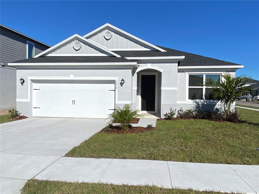 1210 Augustus Drive Davenport, FL 33896 - Photo 1 of 1 a front view of a house with a yard and garage