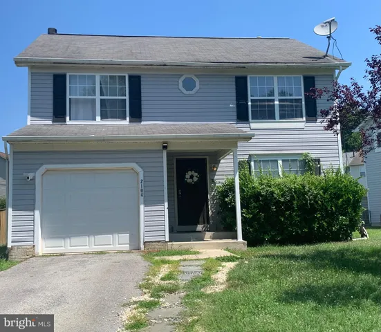 front view of a brick house with a large window