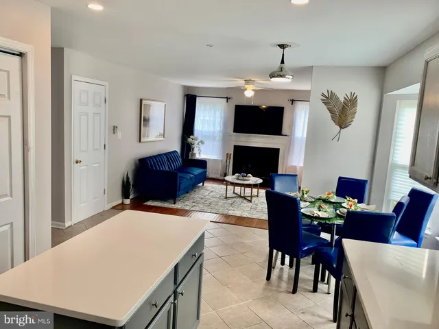 a living room with furniture a fireplace and a chandelier