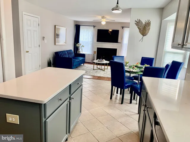 a living room with furniture a flat screen tv and a table