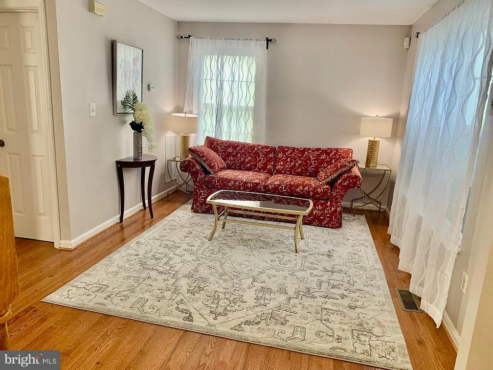 2104 Sayan Court Temple Hills, MD 20748 - Photo 21 of 28 a living room with furniture and a wooden floor