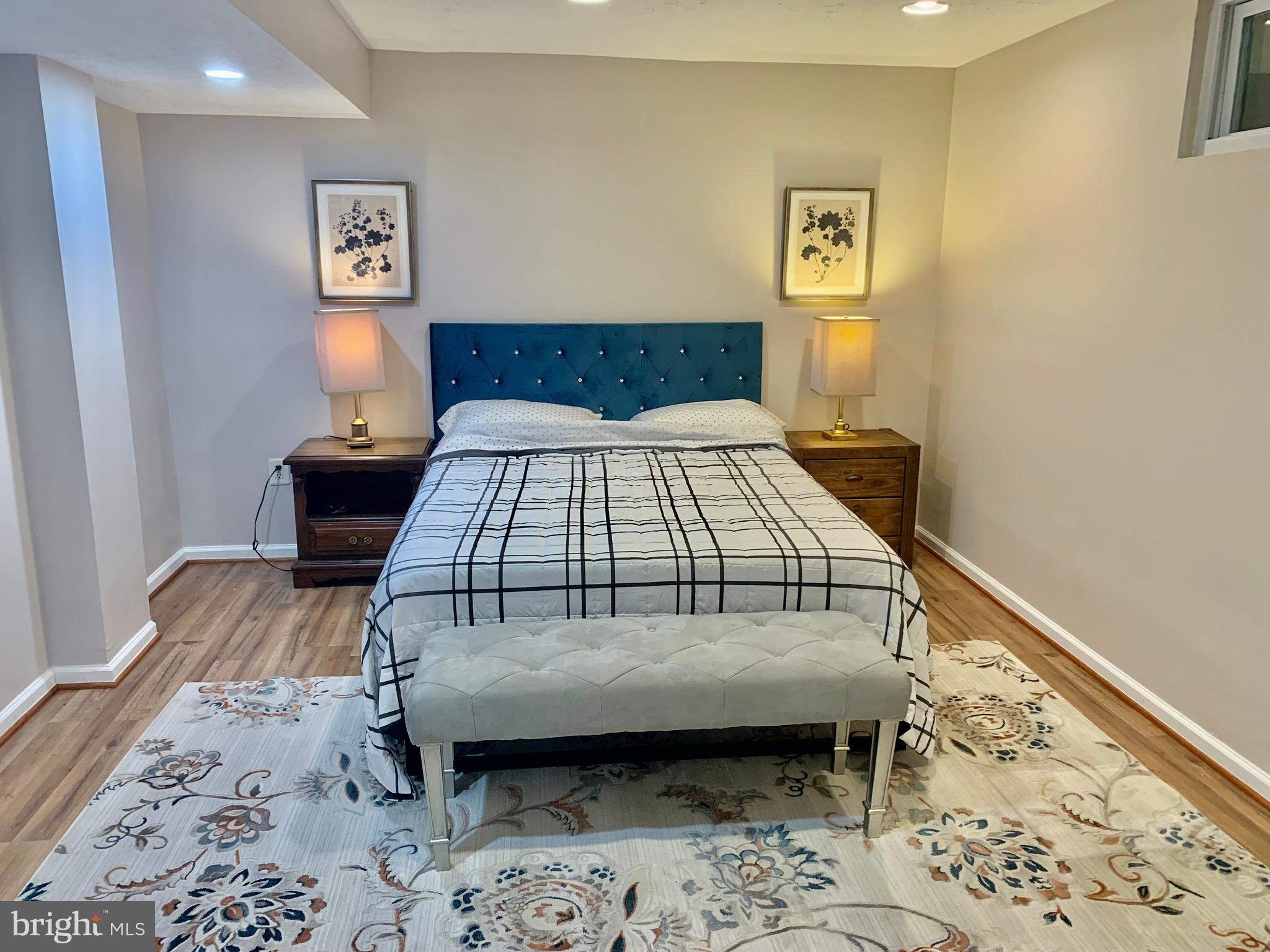 2104 Sayan Court Temple Hills, MD 20748 - Photo 24 of 28 a bedroom with a bed and wooden floor