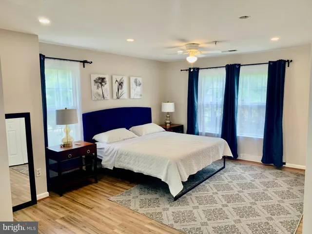 a bedroom with a large bed and a large mirror