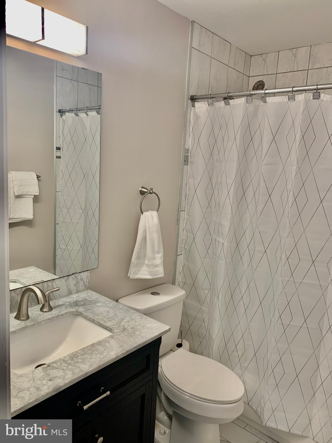 2104 Sayan Court Temple Hills, MD 20748 - Photo 7 of 28 a bathroom with a granite countertop sink and a toilet