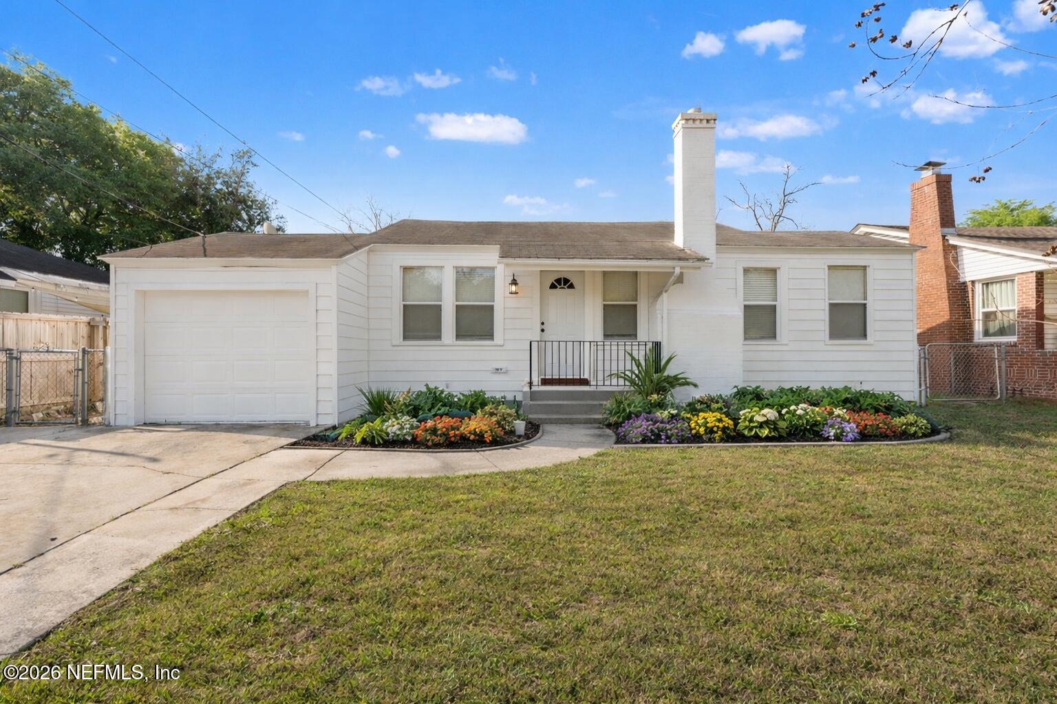 a front view of a house with garden