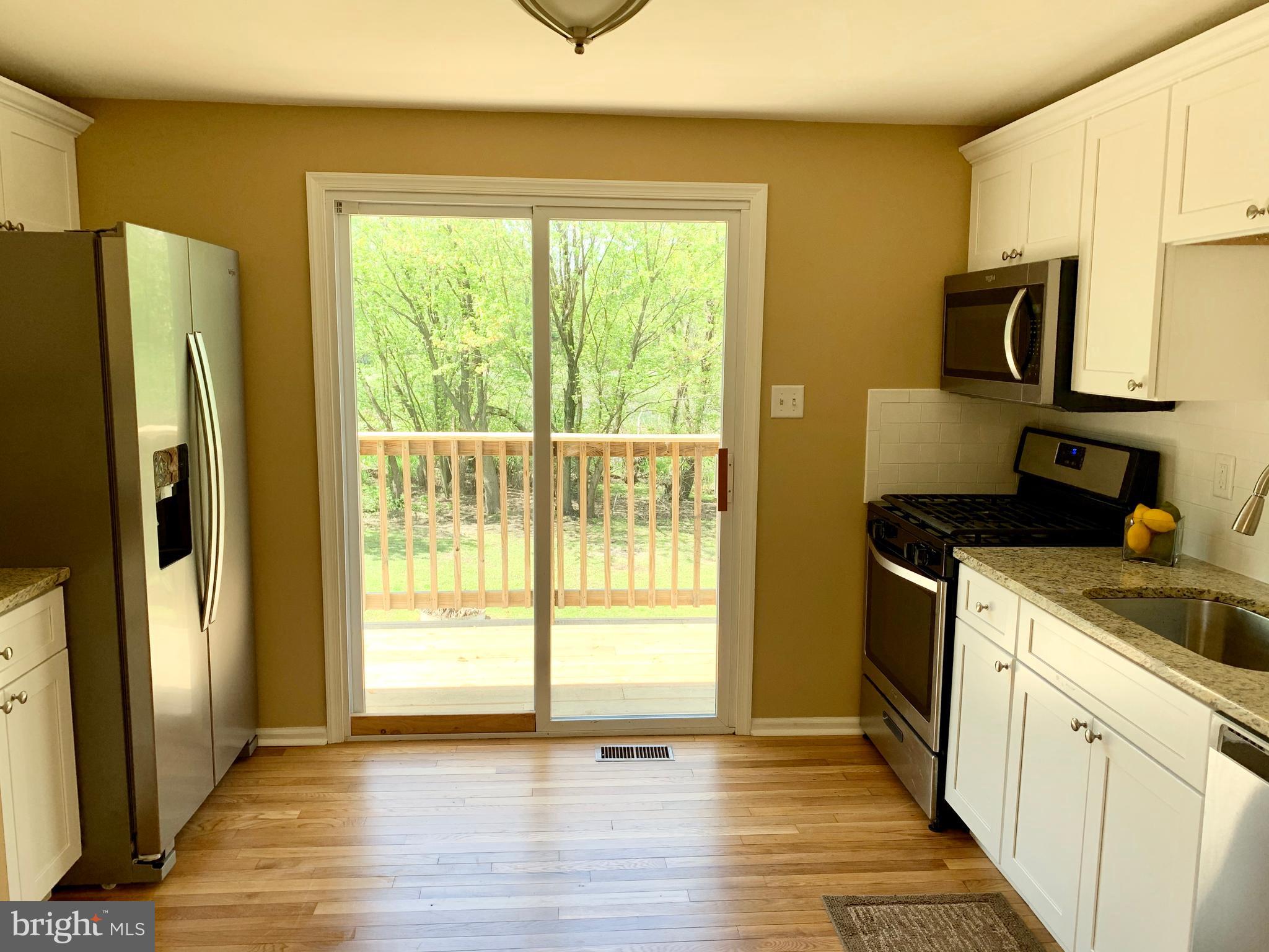 108 West Roland Avenue Maple Shade, NJ 08052 - Photo 7 of 23 a kitchen with stainless steel appliances a refrigerator sink and wooden cabinets