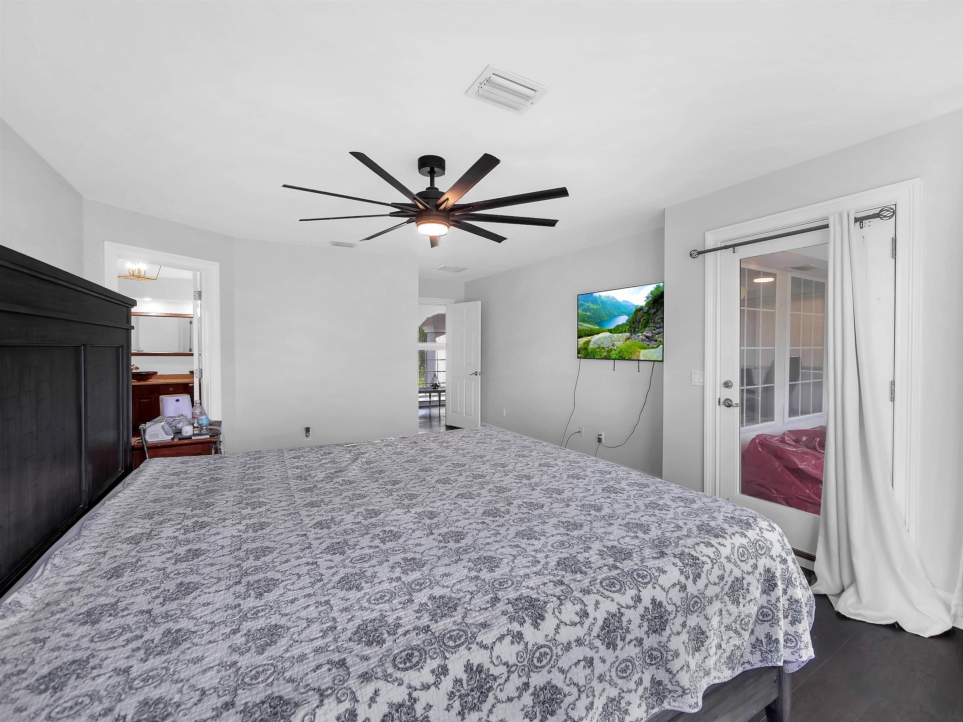 306 Marsh Point Circle St. Augustine, FL 32080 - Photo 21 of 54 a bedroom with a bed and a chandelier