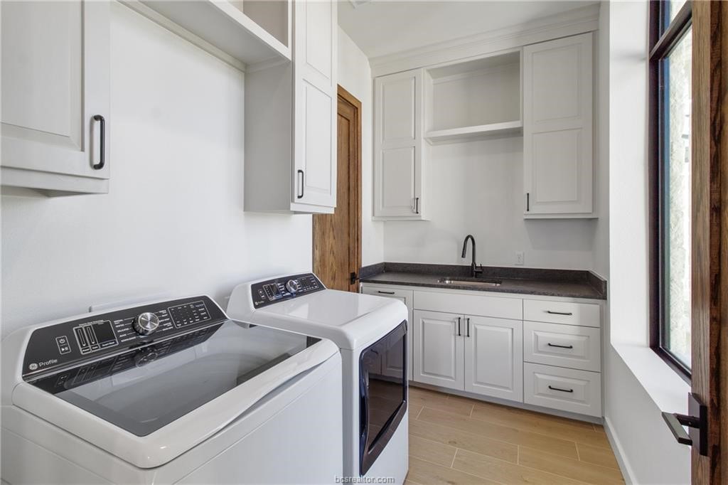 4558 Hicks Lane Bryan, TX 77845 - Photo 16 of 48 a kitchen with sink a stove and cabinets