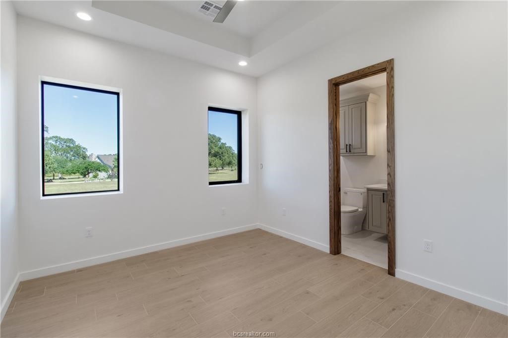 4558 Hicks Lane Bryan, TX 77845 - Photo 17 of 48 an empty room with a window and a ceiling fan