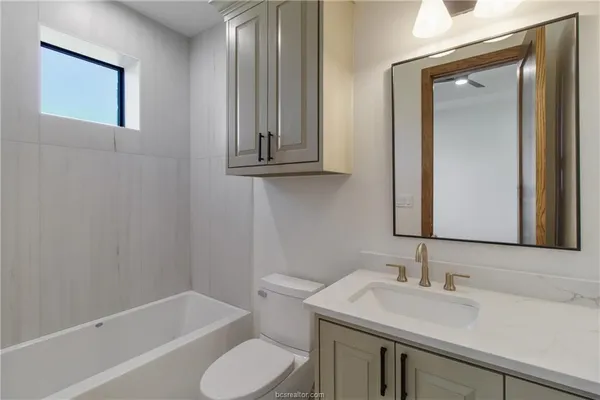 a bathroom with a sink toilet and vanity