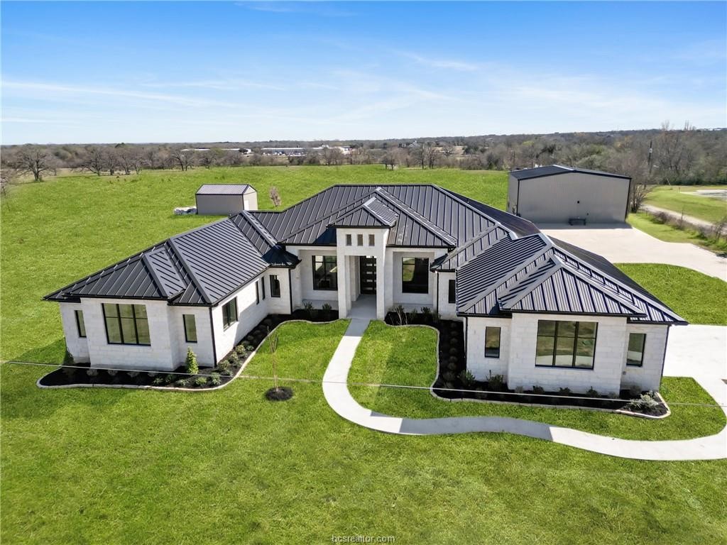 4558 Hicks Lane Bryan, TX 77845 - Photo 2 of 48 a view of a big house with a big yard and large trees