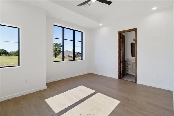 an empty room with windows and closet