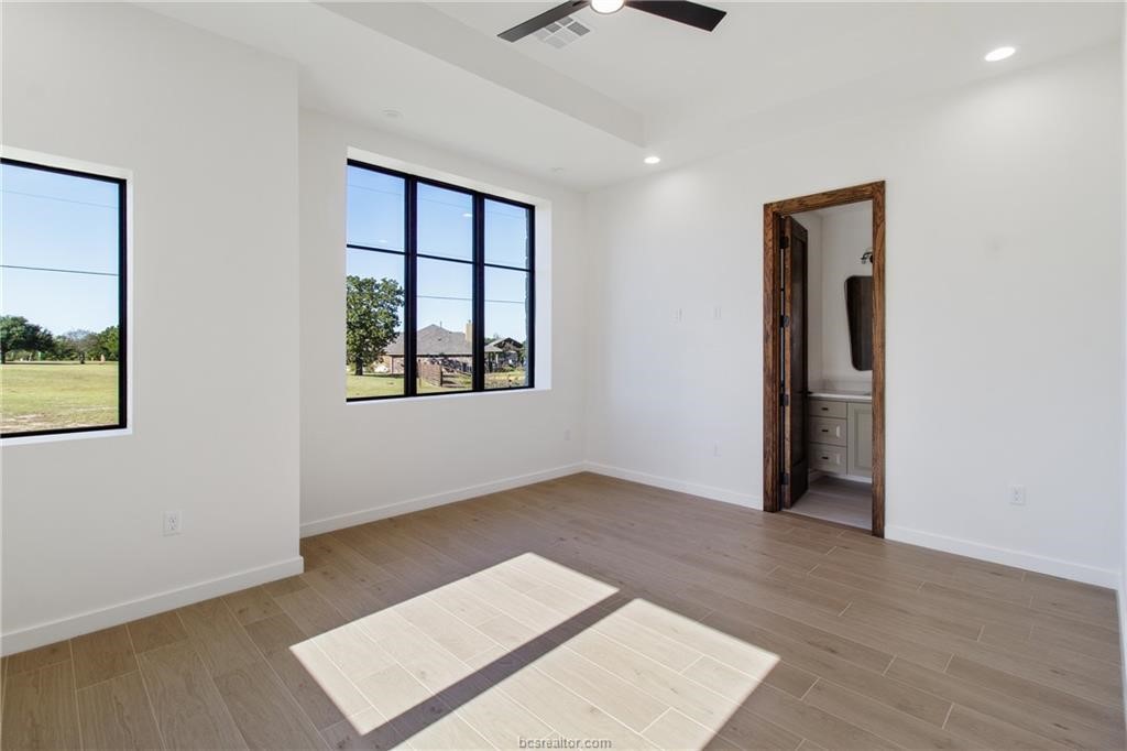 4558 Hicks Lane Bryan, TX 77845 - Photo 23 of 48 an empty room with windows and closet