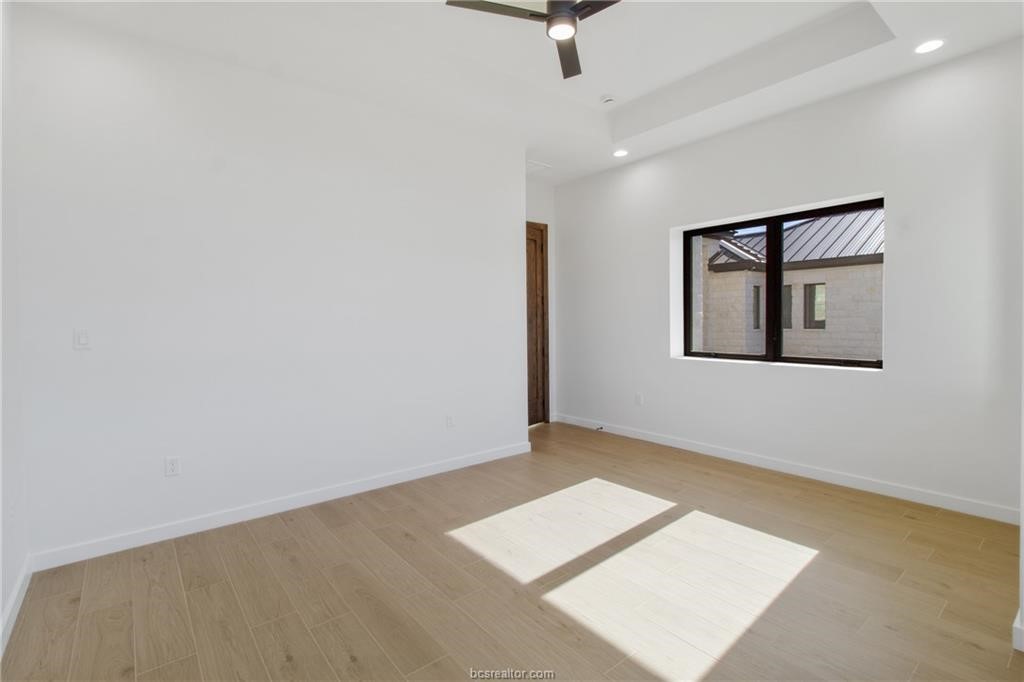 4558 Hicks Lane Bryan, TX 77845 - Photo 24 of 48 an empty room with a ceiling fan and window