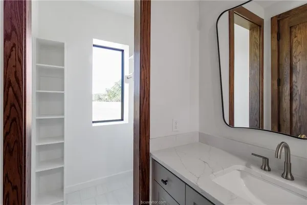 a bathroom with a sink and a mirror