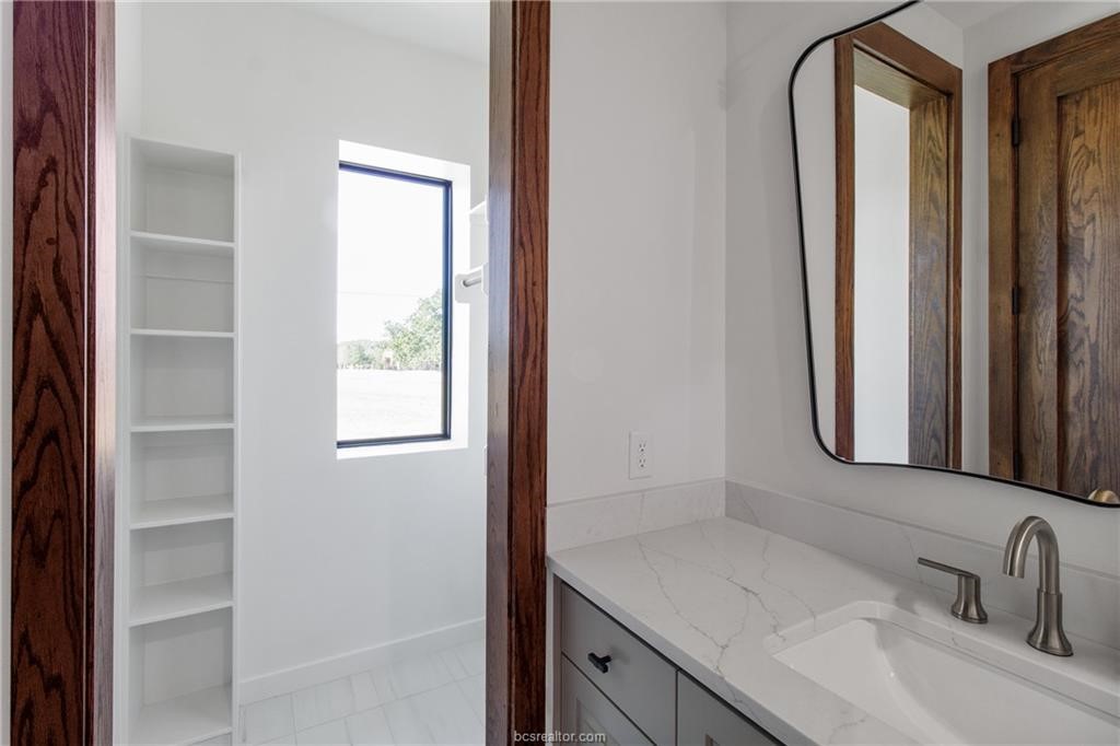 4558 Hicks Lane Bryan, TX 77845 - Photo 26 of 48 a bathroom with a sink and a mirror