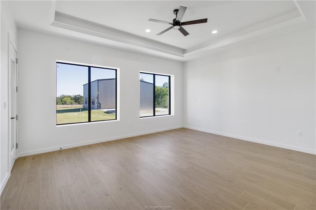 4558 Hicks Lane Bryan, TX 77845 - Photo 27 of 48 a view of an empty room with a window and wooden floor
