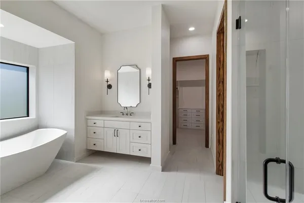 a bathroom with a double vanity sink toilet and shower